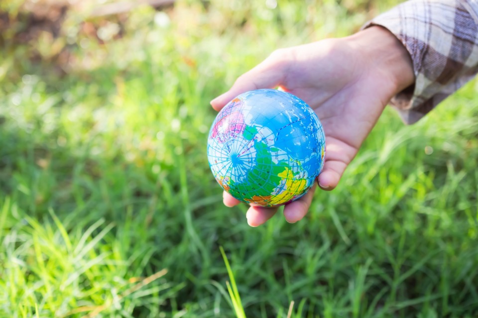 hand-farmer-holding-earth-on-grass-background-2022-11-09-04-27-53-utc